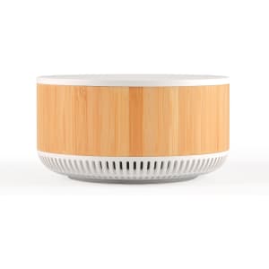 A round speaker and wireless charger with a bamboo timber exterior and a white base. The product features a logo.