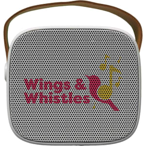 A compact, square mini speaker in white with a brown strap and a logo on the front.