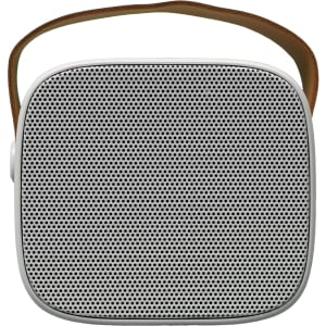 A compact speaker with a square design and mesh front, featuring a brown carrying strap.