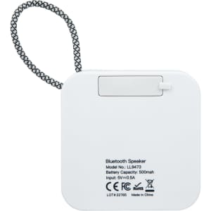 A white Bluetooth speaker with a textured strap and branding on the back. The speaker features a flat, square design.