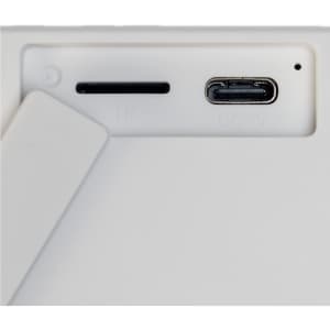 A white speaker featuring a stand and ports for connectivity, including a USB-C port.