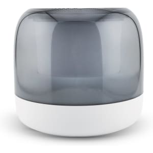 A rounded speaker with a smoke grey top and a white base, featuring a modern design and smooth surface.