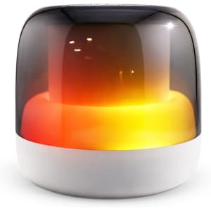 A Dazzle RGB Speaker with a glossy black and white exterior, featuring vibrant warm orange and yellow lighting.