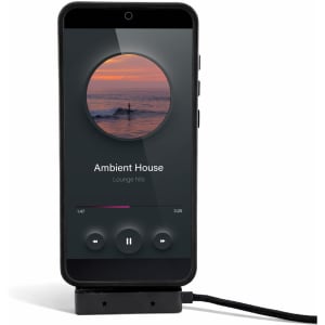 A smartphone displaying a music player interface, connected to a charging cable. The phone is in a protective case.