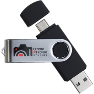 A black and silver swivel USB flash drive with dual connectors and a logo on the side.
