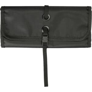 A dark green toiletry bag organizer features a roll-up design with two circular fasteners and a secure strap closure.