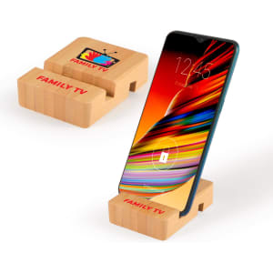 A bamboo phone stand in natural colour, featuring a logo and supporting a smartphone.