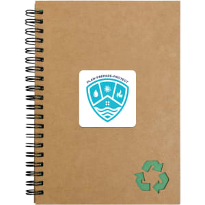 A brown spiral notebook with a green recycling symbol and a logo on the cover.