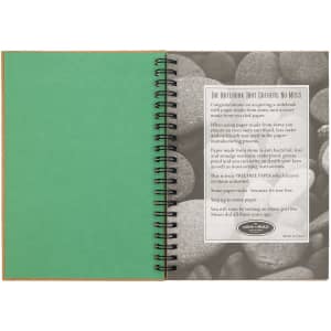 A green Stone Paper Notebook with a spiral binding, featuring a textured interior and a stone-like background.
