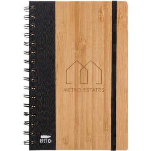 A spiral-bound A5 notebook with a bamboo cover, black fabric side, and an elastic band. It features a logo on the front.