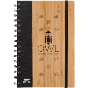 A bamboo A5 notebook featuring a black cover and spiral binding, with a logo and simple illustrations.