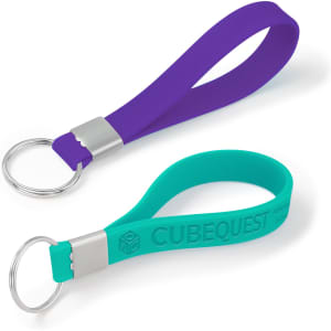 Two silicone strap keytags in purple and teal, featuring metal keyring attachments. One has a logo.
