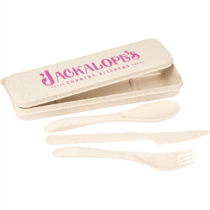 A bamboo fibre cutlery set in cream colour, including a spoon, fork, and knife, housed in a matching case with a logo.