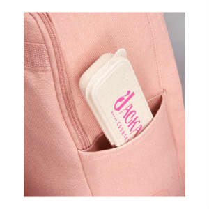 A pink backpack with a cream-coloured bamboo fibre cutlery set case peeking out from a side pocket.