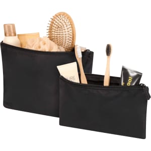 A set of two black toiletry bags filled with various grooming products, including a hairbrush, lotion, and toothbrushes.