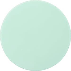 A round mint green makeup mirror with a smooth surface. It features a simple design and has a branding logo.