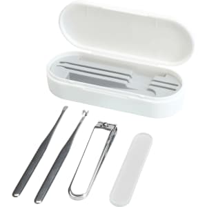 A white manicure set containing a nail clipper, tweezers, and other tools, all housed in a matching case.