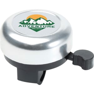 A silver bicycle bell with a black lever and a circular logo featuring mountains and the word "ADVENTURE".