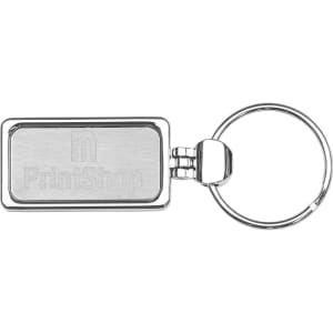 A silver metal keyring with a rectangular pendant and a keyring attachment, featuring a logo.