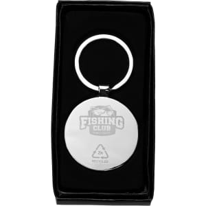 A circular keyring made from recycled zinc alloy with a sleek silver finish, presented in a black box.