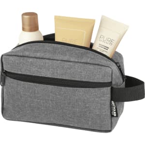 A grey toiletry bag with a zip, containing two tubes of lotion and a bottle of shampoo inside.