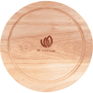 A wooden cheese board with a smooth round surface and a logo engraved in the centre.