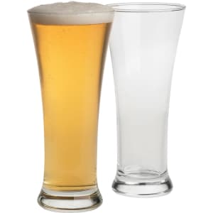 A set of two Pilsner beer glasses, one filled with golden beer and the other clear. Both have a sleek, tall design.