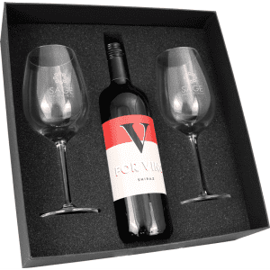 A wine box containing a bottle of Shiraz and two clear wine glasses, all set against a black foam base.
