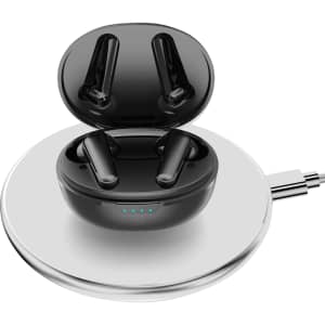 Black wireless earbuds in a glossy charging case, placed on a round charging pad.