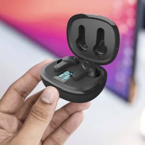 A person's hand holding black Prixton TWS159 ENC and ANC earbuds in their charging case.