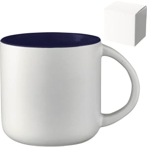 A ceramic mug with a white body and navy blue rim, presented with a plain gift box.