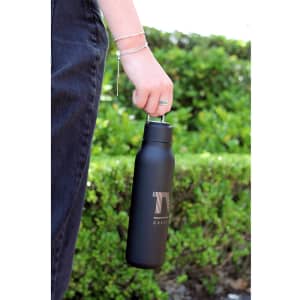 A drink bottle in matte black with a metal loop, featuring a logo and a 600ml capacity.