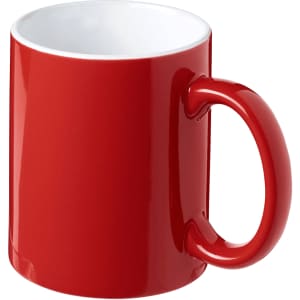 A red ceramic mug with a glossy finish and a white interior, featuring a handle and a logo.