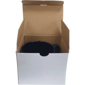 A ceramic mug in black inside a plain cardboard box, featuring a handle and a simple design.