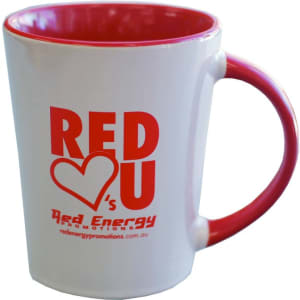 A ceramic coffee mug with a white exterior and a red interior, featuring a logo.