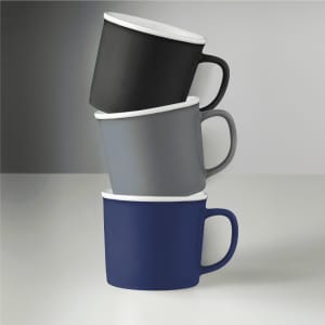 Three ceramic mugs in black, grey, and navy stacked with white interiors, featuring a logo on the side.