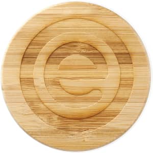 A bamboo lid featuring a circular design, crafted from light brown bamboo wood. Suitable for a glass cup.