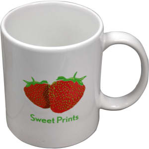 A white ceramic mug featuring a strawberry design and a logo, presented in a folded box.