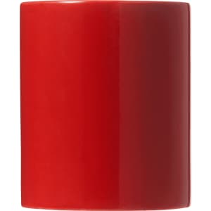 A ceramic mug in vibrant red, presented in a folded box, featuring a smooth, glossy finish.