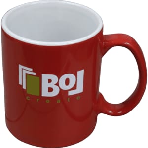 A red ceramic mug with a white interior and a logo, packaged in a folded box.