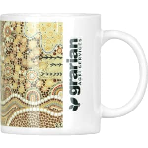 A ceramic coffee mug with a decorative Aboriginal-inspired design and a logo on the side.