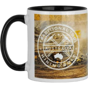 A two-tone ceramic mug featuring a black handle and interior, displaying a mining scene and a logo.