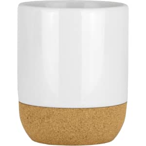 A ceramic mug with a white upper section and a cork base, featuring a smooth finish and a logo.