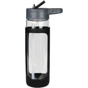 A drink bottle with a transparent glass body, grey silicone cover, and flip-top lid for easy sipping.