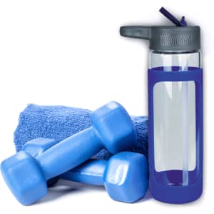 A drink bottle with a grey lid and blue silicone cover, alongside blue dumbbells and a blue towel.