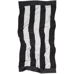 A black and white striped beach towel with a solid coloured border and a logo at one end.