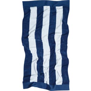 A beach towel featuring alternating navy blue and white stripes, with a branded logo on the corner.