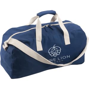 A navy blue duffle bag with cream handles and a logo on the front. It features a zip closure and shoulder strap.