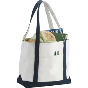 A heavy weight cotton boat tote in cream with navy accents, featuring side pockets and sturdy straps.