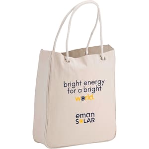 A beige organic cotton tote bag with rope handles, featuring a logo and text on the front.